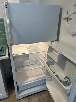 an empty refrigerator with its door open in a kitchen at Casa Di Nonna in Wasaga Beach