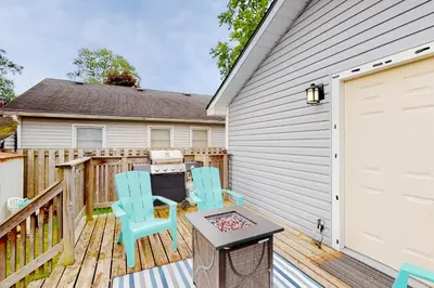 a patio with two chairs and a table on a deck at Mary Jane's Cottage in Crystal Beach