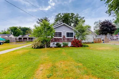a white house with a yard at Mary Jane's Cottage in Crystal Beach