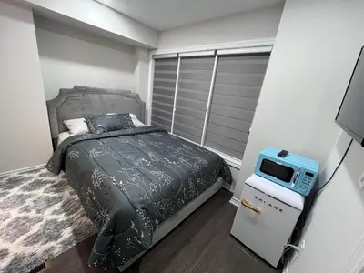 a bedroom with a bed and a tv in it at New Kleinburg Towns in Woodbridge