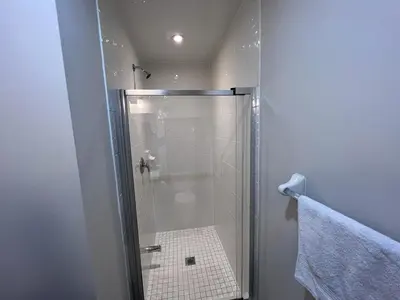 a shower with a glass door in a bathroom at New Kleinburg Towns in Woodbridge