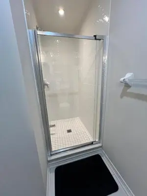 a shower with a glass door in a bathroom at New Kleinburg Towns in Woodbridge