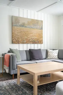 a living room with a couch and a table at The Birch in Wellington