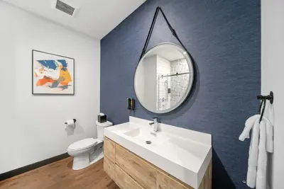 a bathroom with a white sink and a mirror at Cannery Lofts Niagara in Niagara Falls