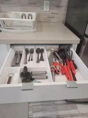 a kitchen stove with utensils in a drawer at Modern studio with kitchenette and bath in Guelph