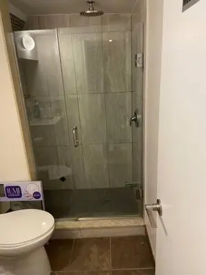a bathroom with a glass shower with a toilet at BASEMEWNT Room with private bathroom 36C in Toronto