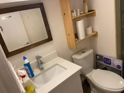 a bathroom with a toilet and a sink and a mirror at BASEMEWNT Room with private bathroom 36C in Toronto