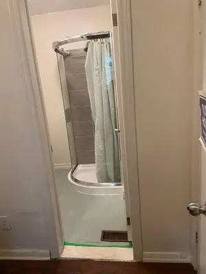 a shower in a bathroom with the door open at BUDGET Triple Room with En Suite Bathroom 36A in Toronto