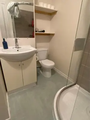 a bathroom with a toilet and a sink and a shower at BUDGET Triple Room with En Suite Bathroom 36A in Toronto