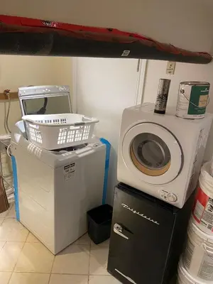 a washing machine and a washer and dryer in a room at BUDGET Triple Room with En Suite Bathroom 36A in Toronto