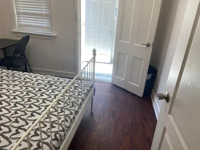 a bedroom with a bed and a door with a window at BUDGET Quad Room with En Suite Bathroom 36B in Toronto