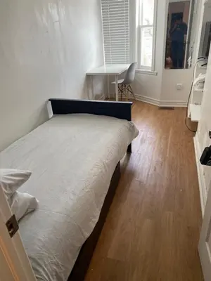 a bedroom with a bed and a desk in a room at Single Room with SHARED Bathroom 536C in Toronto