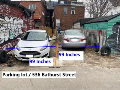 two cars parked in a parking lot brilliant street at Single Room with SHARED Bathroom 536C in Toronto