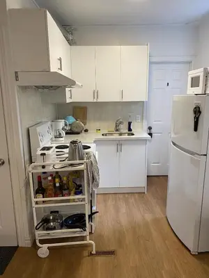 a kitchen with white cabinets and a white refrigerator at Single Room with SHARED Bathroom 536C in Toronto