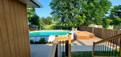a swimming pool in a yard next to a fence at Spacious Guest Suite in Hamilton