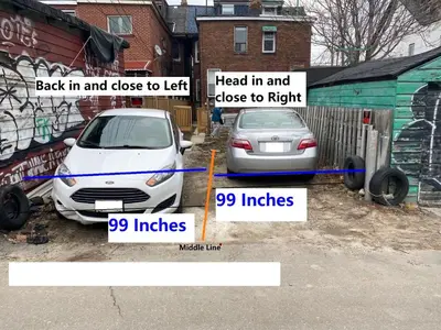 a car parked in a parking lot next to a garage at Quad Room with Private Bathroom 536A-Two Bedrooms in Toronto