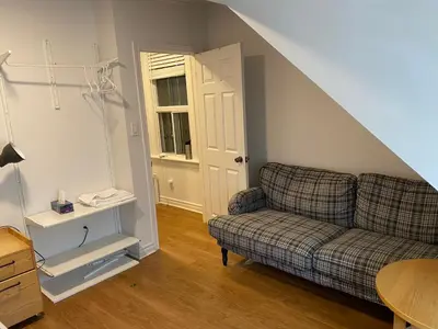 a living room with a couch and a table at Quad Room with Private Bathroom 536A-Two Bedrooms in Toronto