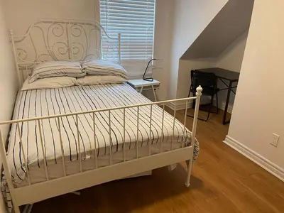 a white bed in a room with a staircase at Quad Room with Private Bathroom 536A-Two Bedrooms in Toronto