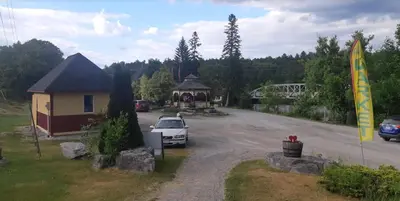a car parked in a parking lot next to a building at Burnt River Bungalow in Kinmount