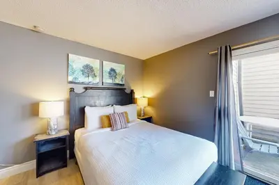 a bedroom with a large bed and a window at Condo 612 at North Creek Resort in Blue Mountains