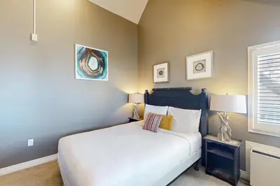 a bedroom with a white bed and a window at Condo 612 at North Creek Resort in Blue Mountains