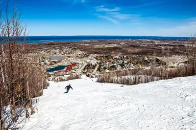 a person riding a snowboard down a snow covered slope at Condo 612 at North Creek Resort in Blue Mountains