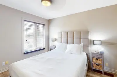 a white bedroom with a large bed and a window at Sierra Lane 105 in Blue Mountains