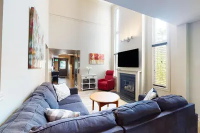 a living room with a blue couch and a fireplace at Sierra Lane 105 in Blue Mountains
