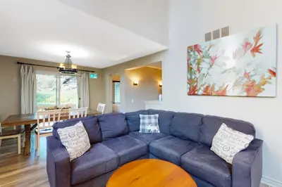 a living room with a blue couch and a table at Sierra Lane 105 in Blue Mountains