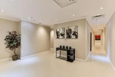 a large hallway with a black table and a plant at NU Hotel Toronto Airport in Mississauga