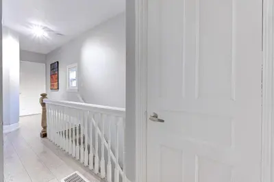 a hallway with a white door and a staircase at Niagara Falls-Toronto-45 Min Drive- 26 OOOO75-Max 8 in Hamilton