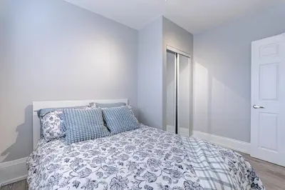 a white bedroom with a bed with blue pillows at Niagara Falls-Toronto-45 Min Drive- 26 OOOO75-Max 8 in Hamilton
