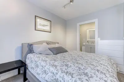 a white bedroom with a bed and a table at Niagara Falls-Toronto-45 Min Drive- 26 OOOO75-Max 8 in Hamilton