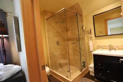 a bathroom with a shower with a glass door at 23Maple in Haliburton