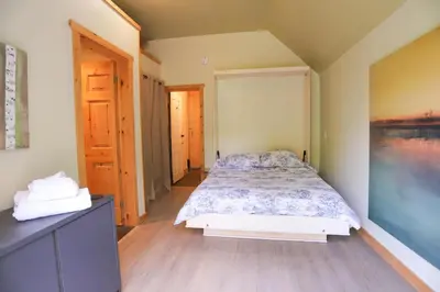 a bedroom with a bed and a dresser at 23Maple in Haliburton