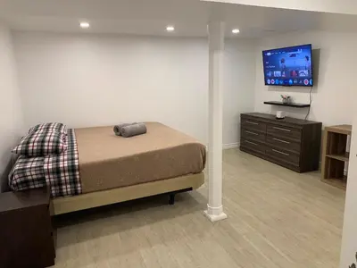 a bedroom with a bed and a flat screen tv at Lovely apartment house in Grimsby
