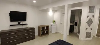 a living room with a flat screen tv on a wall at Lovely apartment house in Grimsby