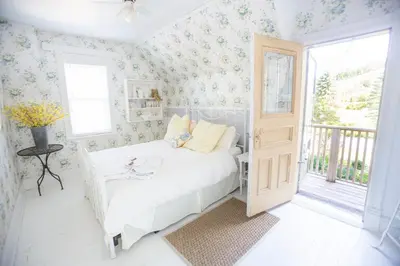 a bedroom with a white bed and a window at Foxingham Farm Bed & Breakfast in Mulmur
