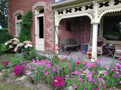a garden with flowers in front of a house at Foxingham Farm Bed & Breakfast in Mulmur
