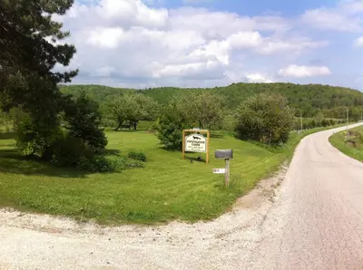 a sign on the side of a road at Foxingham Farm Bed & Breakfast in Mulmur