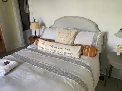 a bed with several pillows on top of it at Foxingham Farm Bed & Breakfast in Mulmur