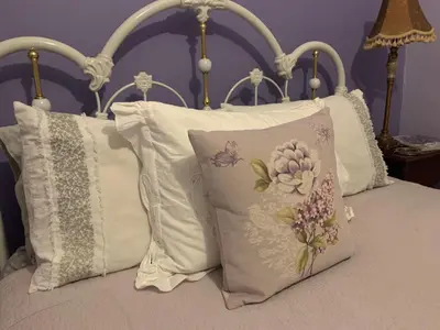 a group of pillows on a bed with at Foxingham Farm Bed & Breakfast in Mulmur