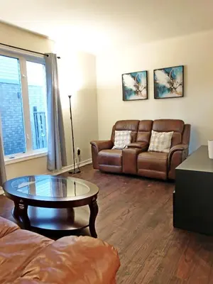 a living room with a couch and a coffee table at Home Pearl B&B in Niagara Falls