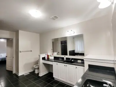 a white bathroom with a sink and a toilet at Home Pearl B&B in Niagara Falls