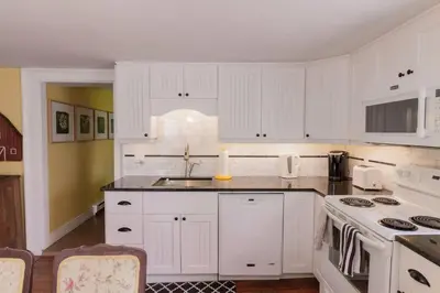 a kitchen with white cabinets and a stove top oven at Wine Country 4 bedrooms in Wellington