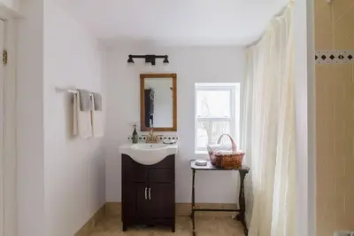 a bathroom with a sink and a mirror at Wine Country 4 bedrooms in Wellington