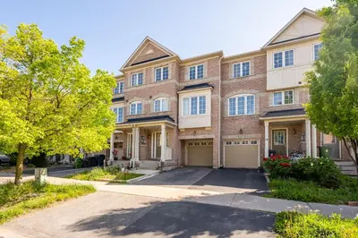a brick apartment building with a driveway at Beautiful Townhouse In Toronto in Toronto