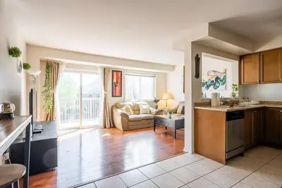 a kitchen and a living room with a couch at Beautiful Townhouse In Toronto in Toronto
