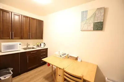 a kitchen with a wooden table and a microwave at Phoebe Wang in Toronto