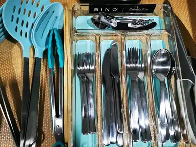 a group of silver utensils in a container at *Cozy, newly renovated, fully equipped* in Hamilton